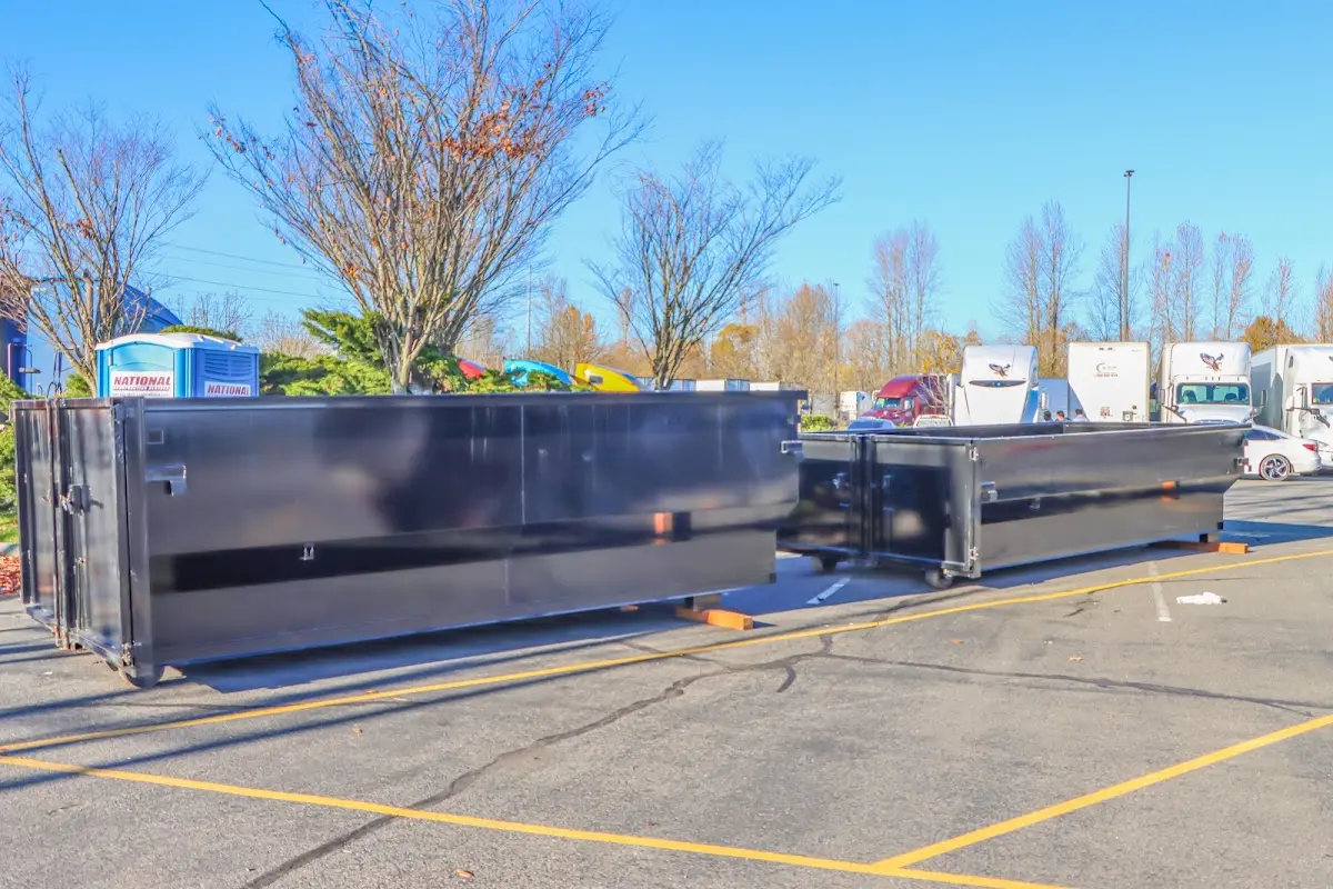 Professional dumpster rental service with roll-off container on residential driveway in Conley